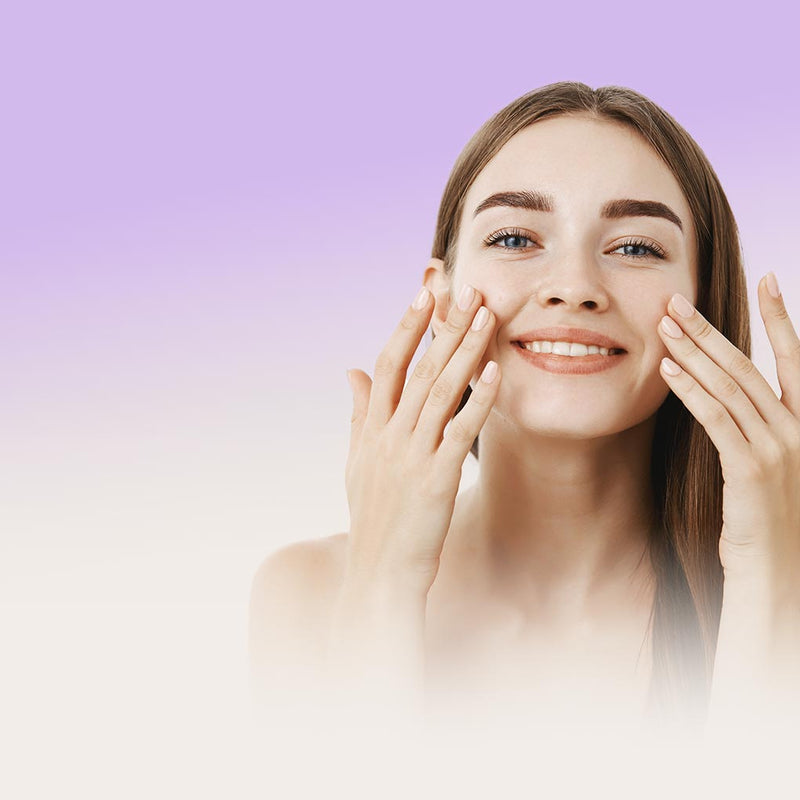 Model using skincare on her face